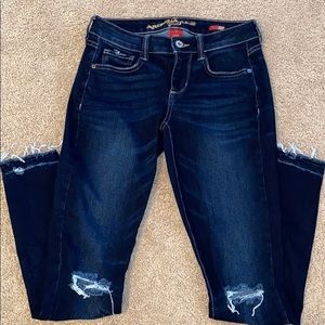 Super skinny blue jeans with rips at the knee